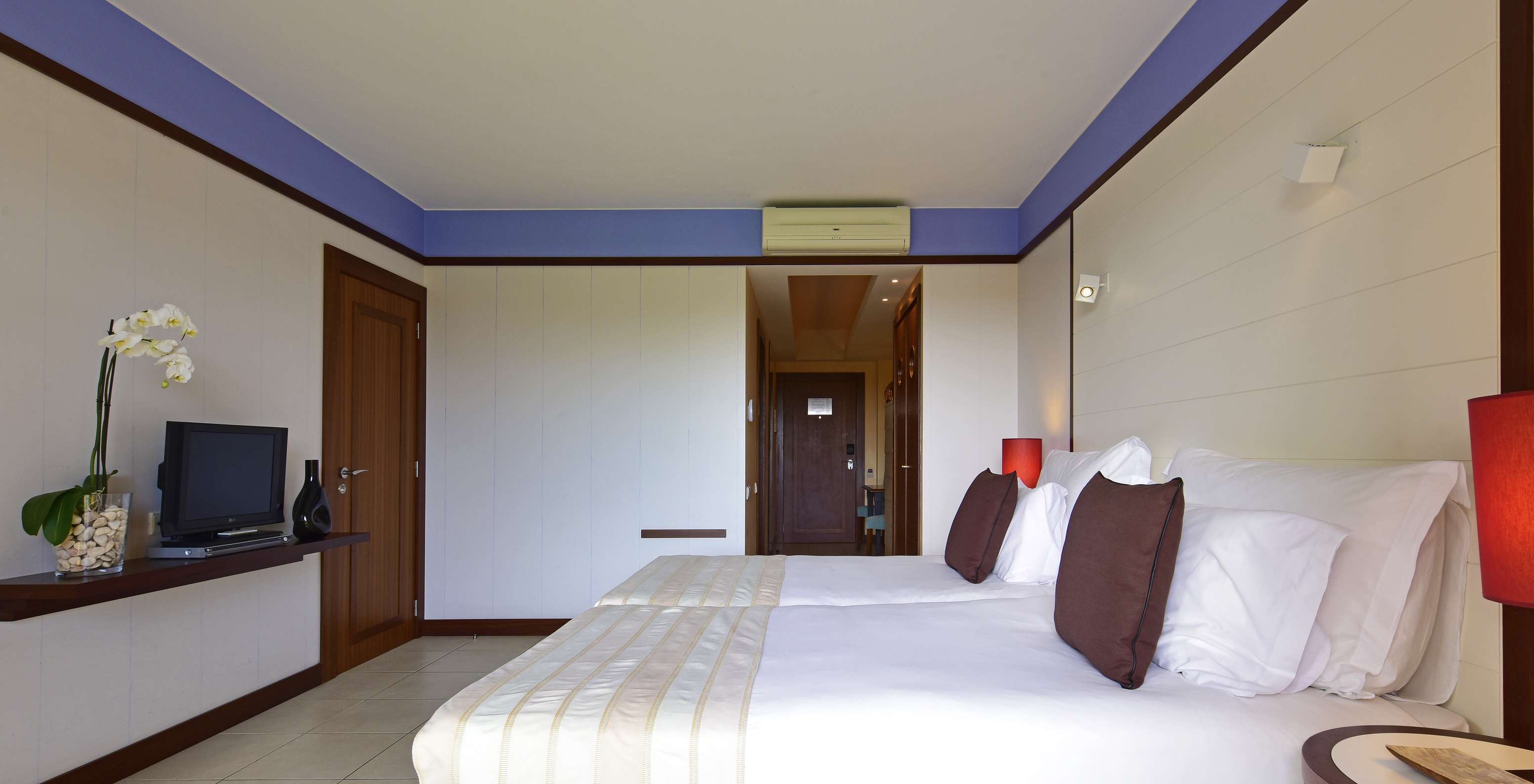 The Classic Double of Pestana Porto Santo All Inclusive has two beds, two nightstands, and a television