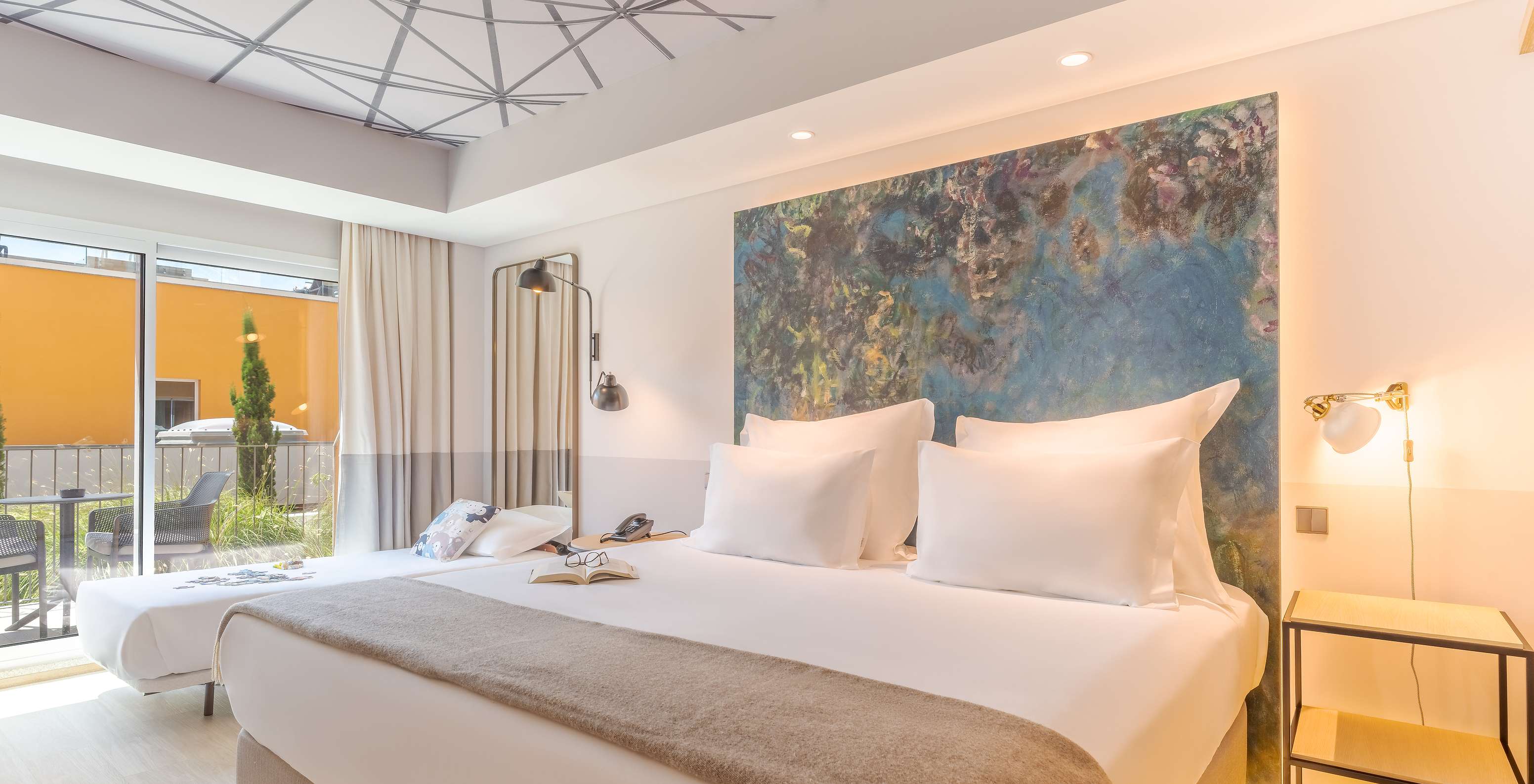 The Superior room at Pestana Douro Riverside has a double bed and a small bed, bedside table, and balcony