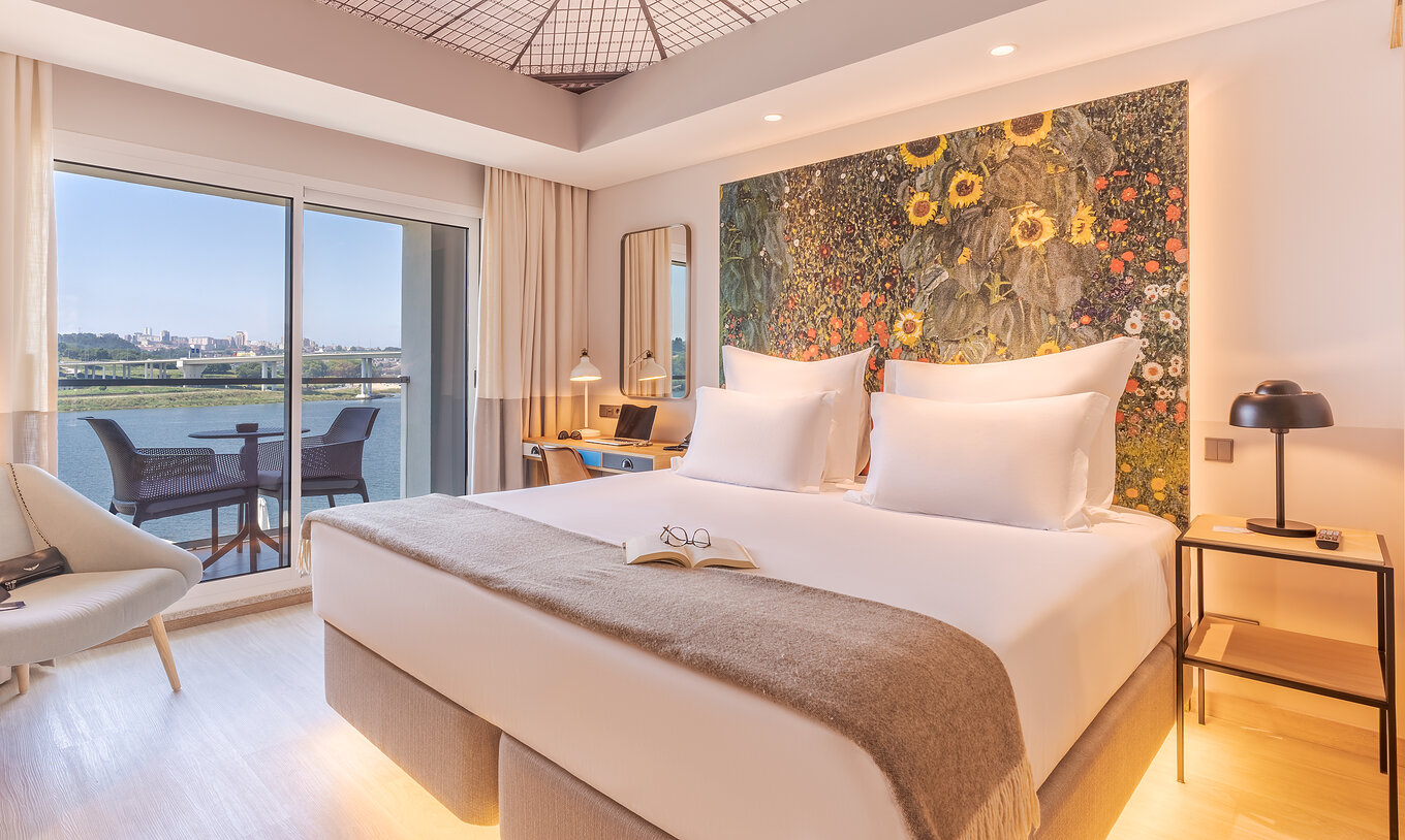 The Grand River View at Pestana Douro Riverside has a double bed, bedside table, and balcony with a view
