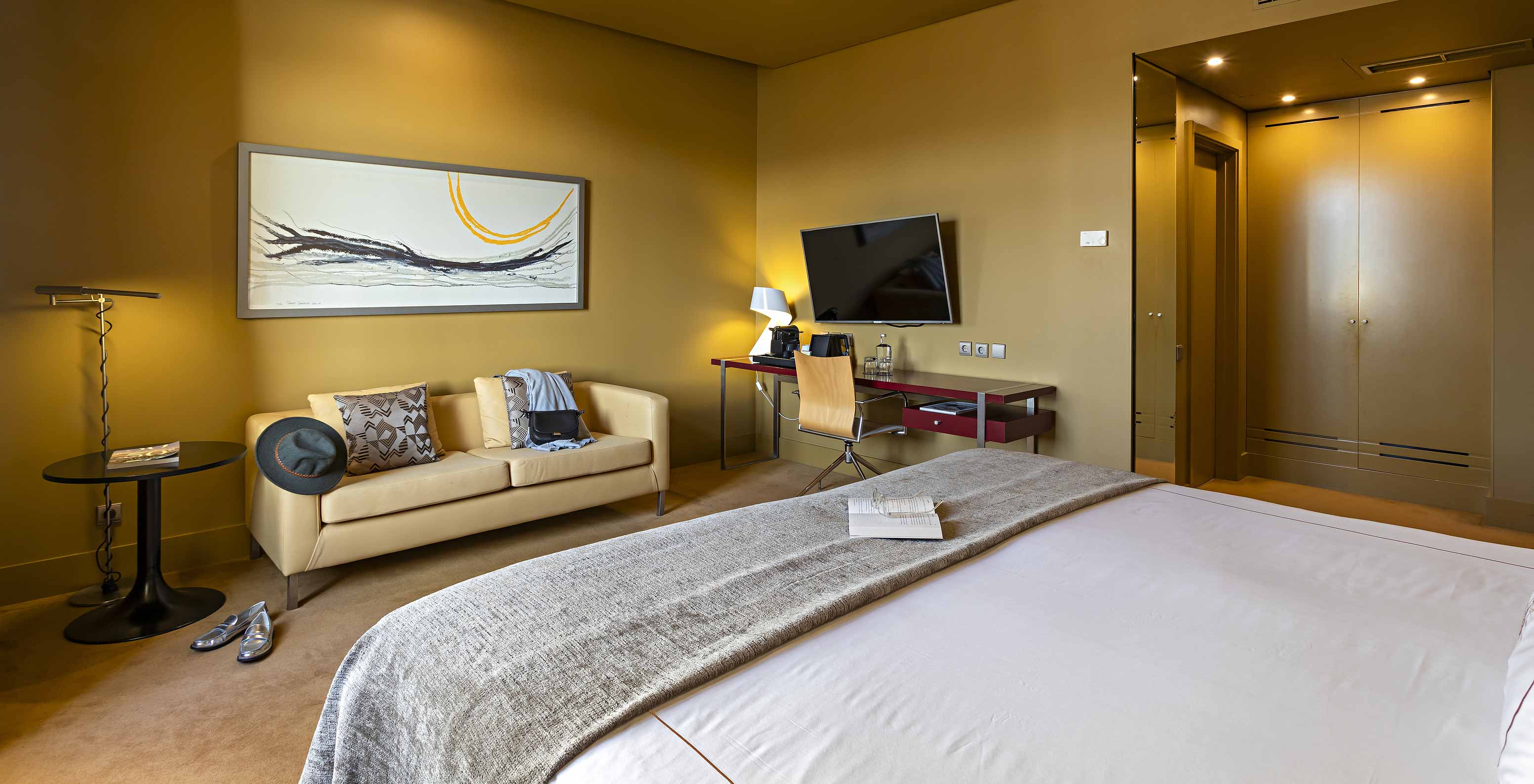 The Executive has a double bed, a sofa, a TV, and a desk