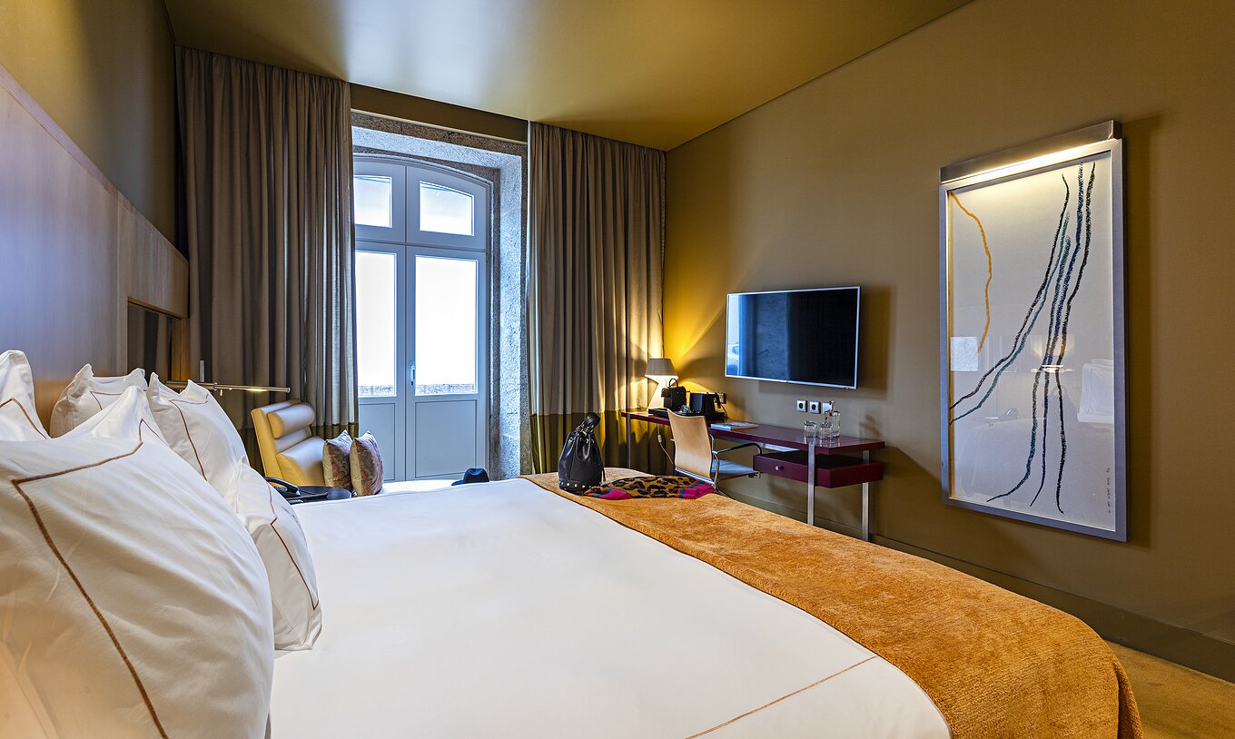 Pestana Palácio do Freixo’s Classic room has a TV in front of the double bed and a window