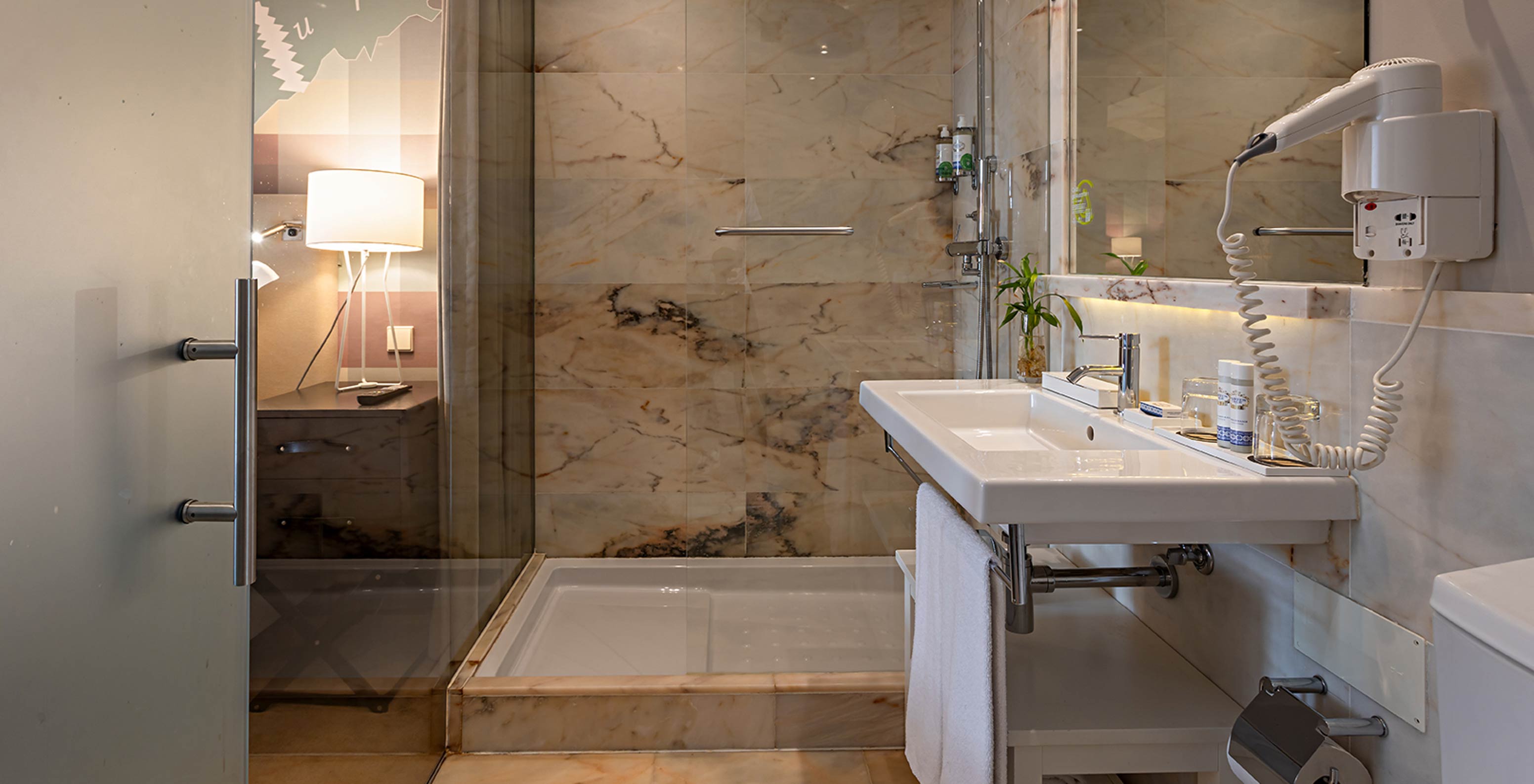 The Classic at Pestana Vintage Porto has a bathroom with a sink and a shower surrounded by marble walls