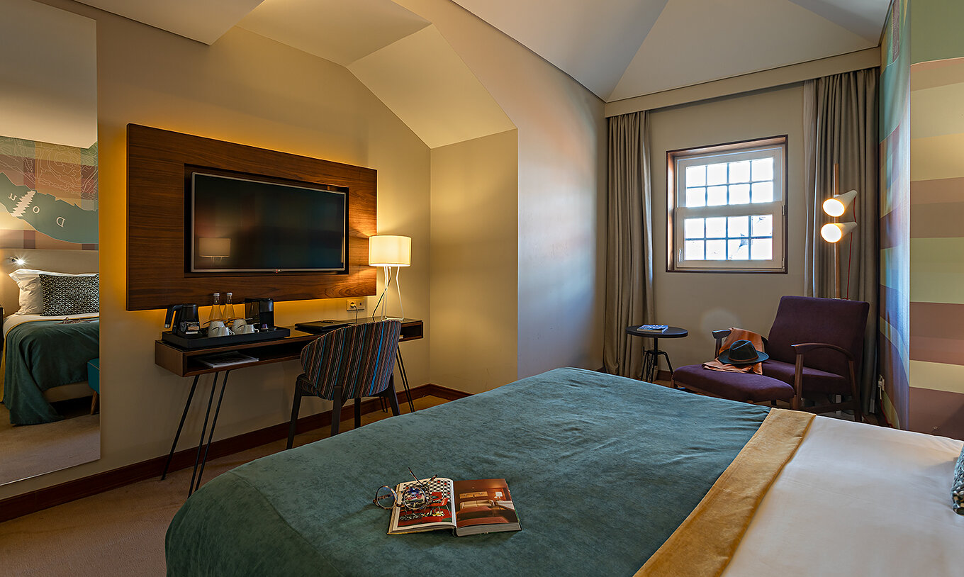 The Classic at Pestana Vintage Porto has a television in front of the bed, a window with a view and a mirror