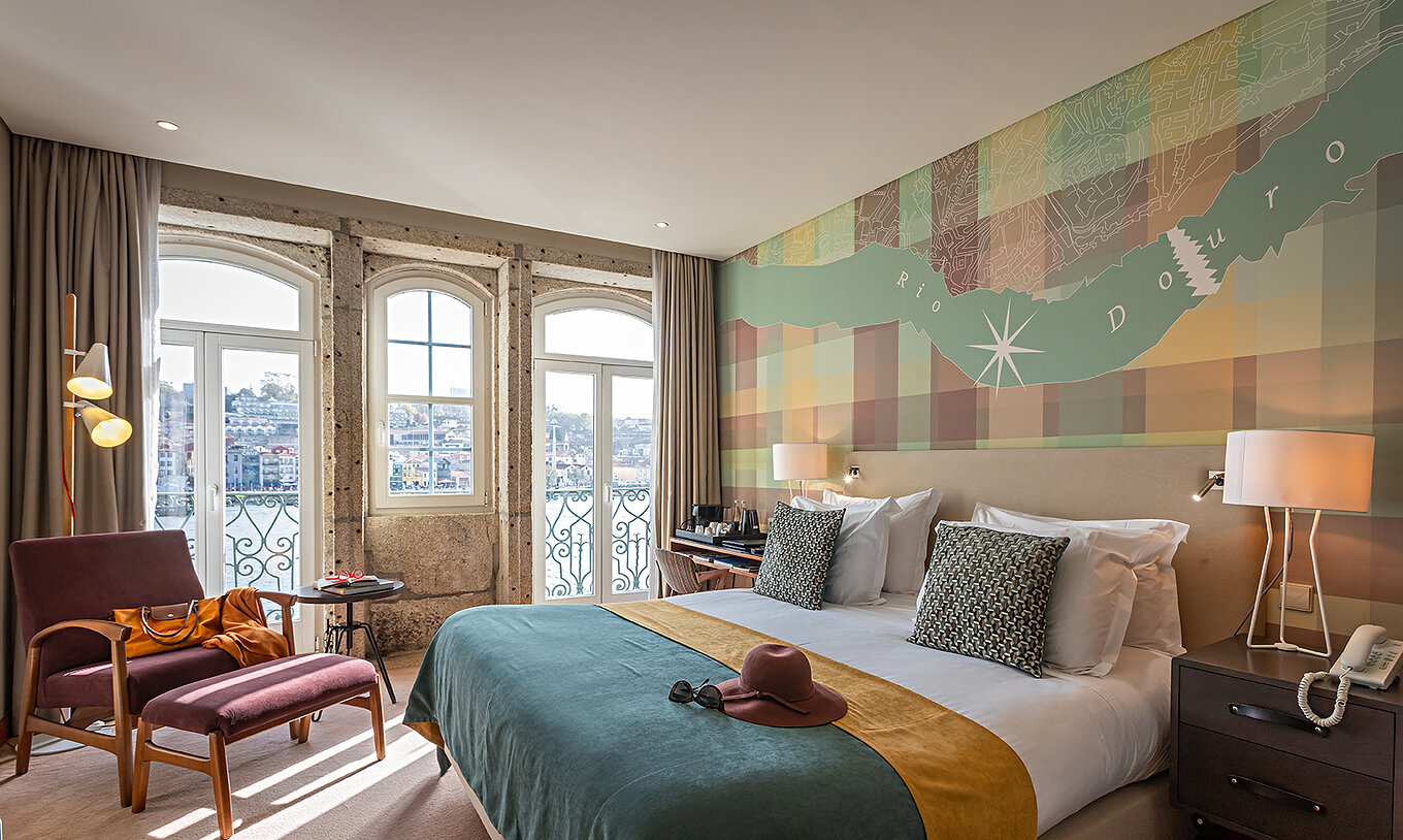 The Vintage River View Balcony at Pestana Vintage Porto has a double bed and large windows with a view of Porto