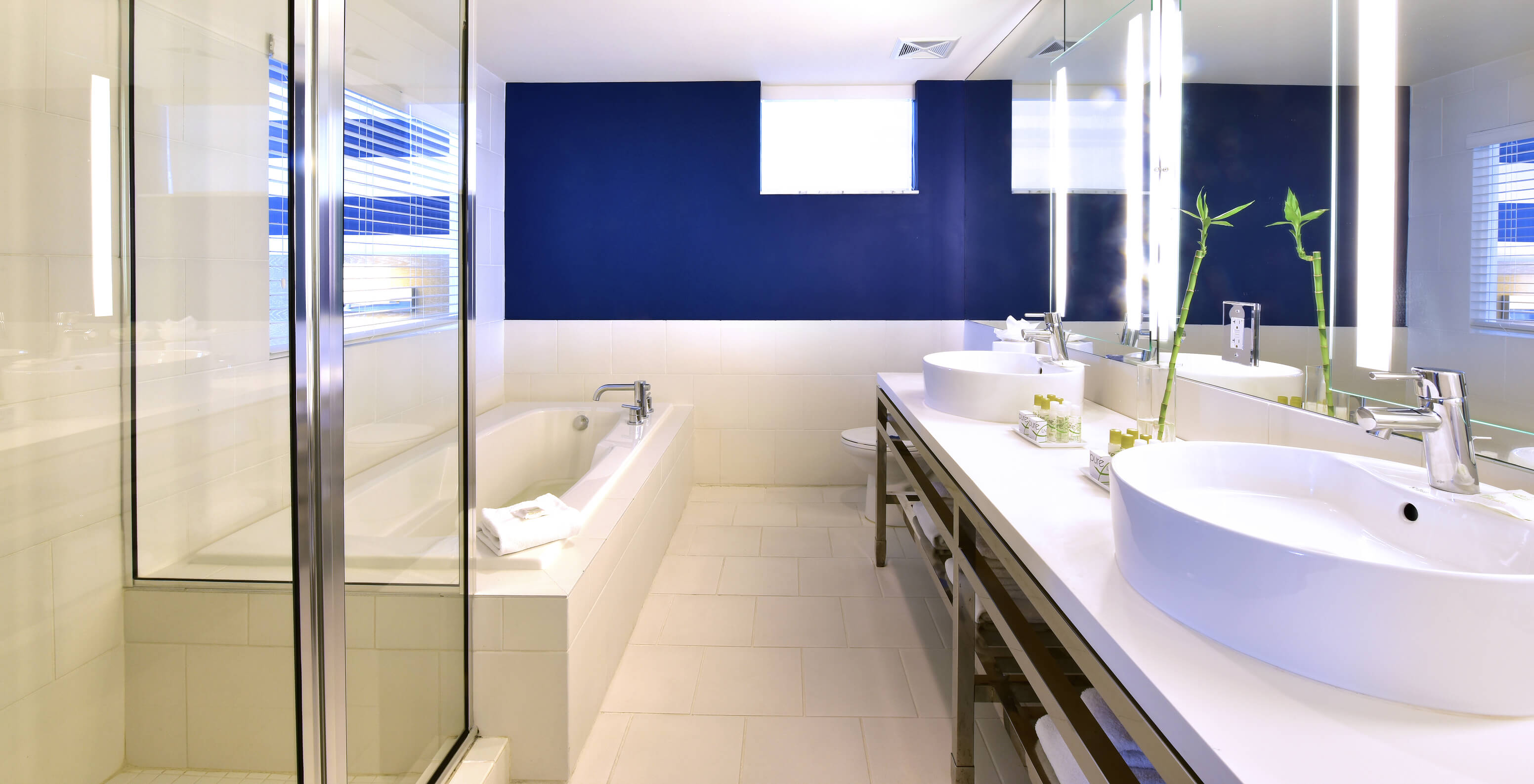 The Suite King with Balcony at Pestana Miami South Beach has a sink, large mirror, and shower or bathtub
