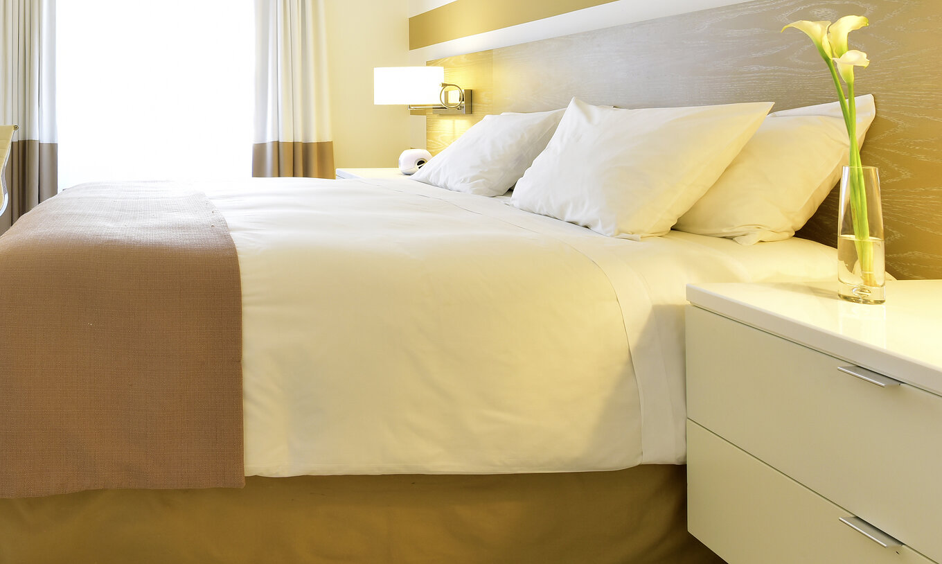 The Classic King - ADA at Pestana Miami South Beach has a double bed, bedside table and closet