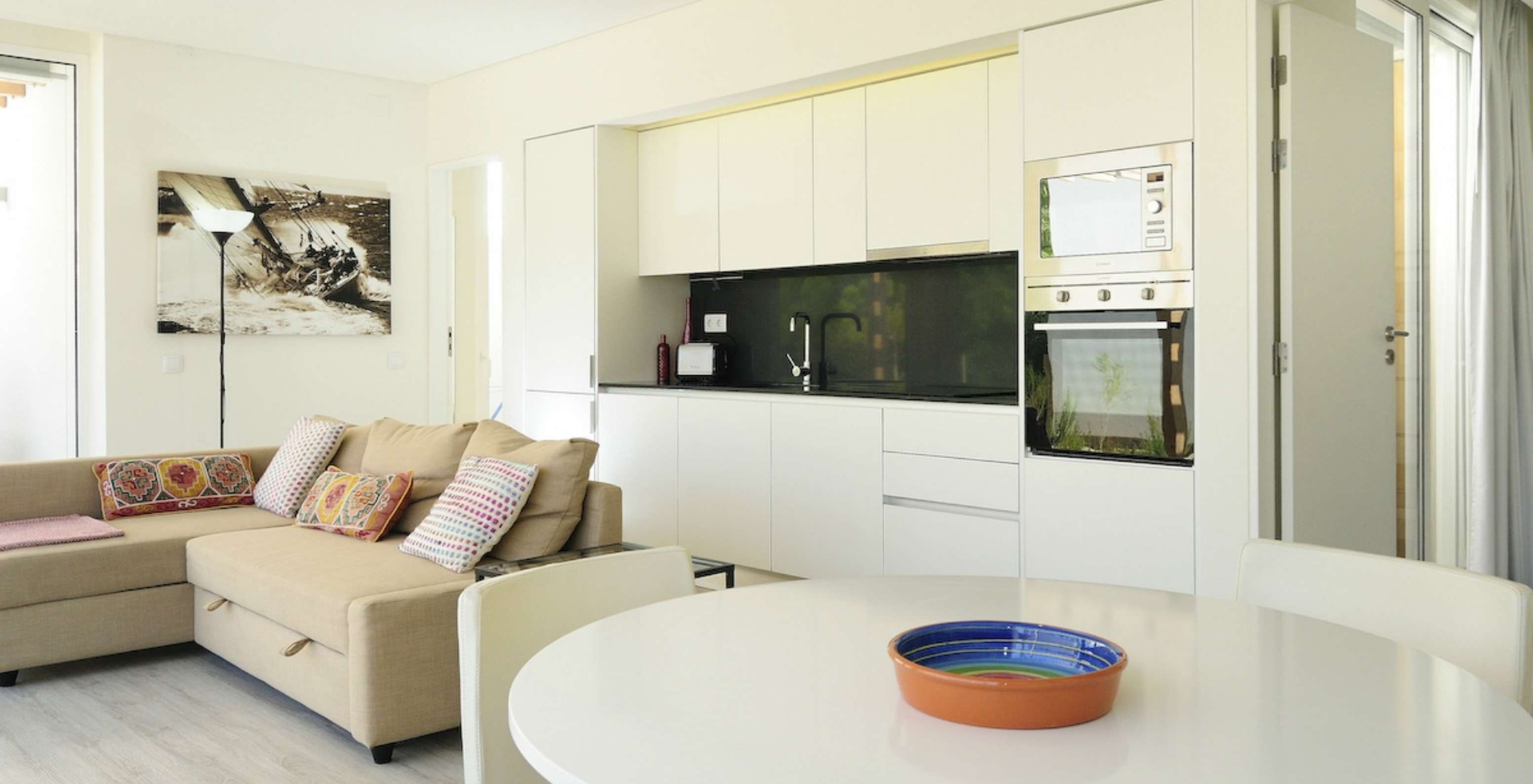 La Green Villa con Piscina Privada T3 del Pestana Tróia Eco Resort tiene una sala junta con la cocina, sofá y mesa para cenar