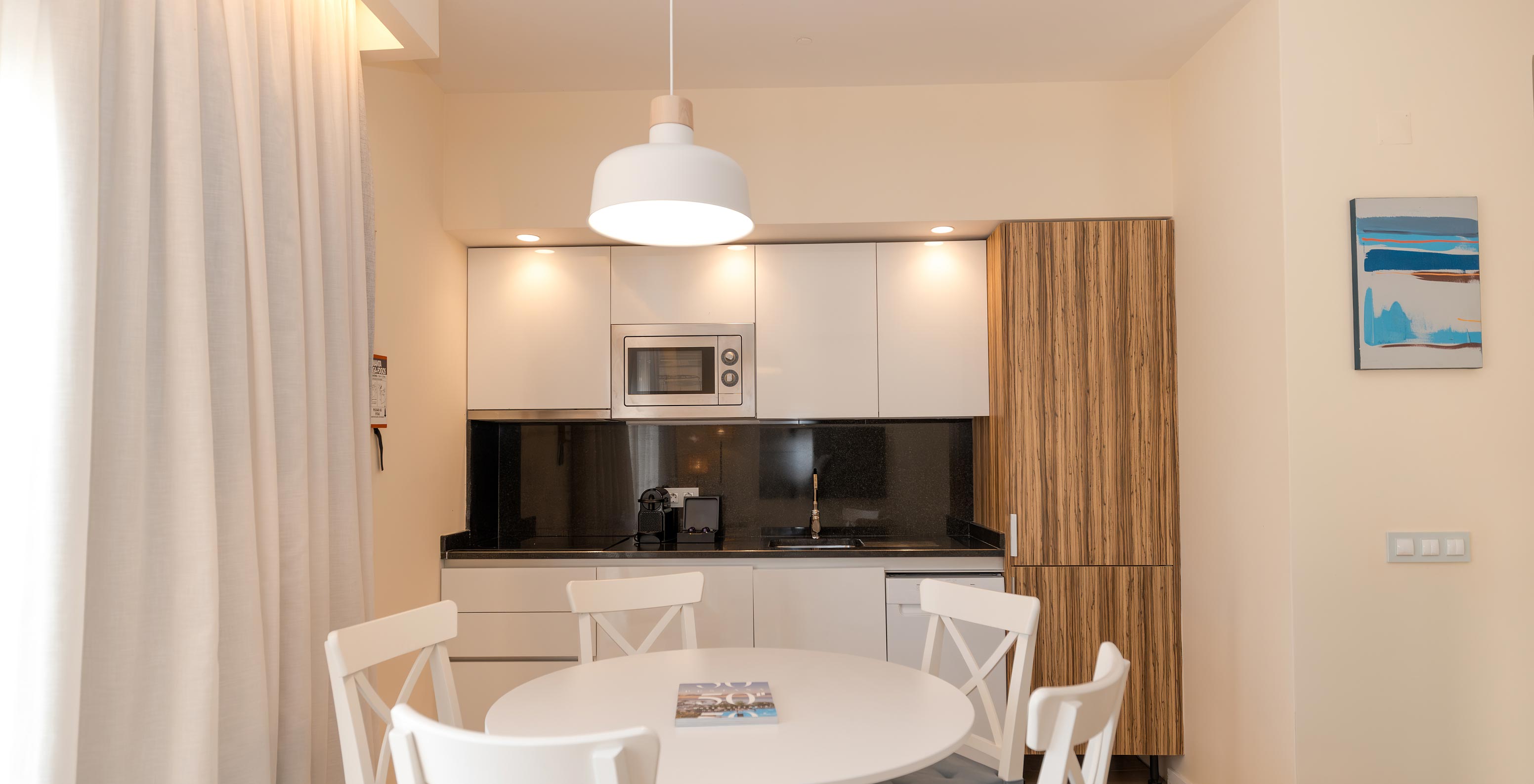 Villa 2 Habitaciones Superior Vista Jardín en Pestana Alvor Beach Villas tiene mesa de comedor y cocina equipada