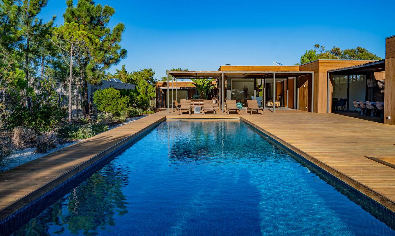 Les Deluxe Villas avec piscine privée du Pestana Tróia Eco Resort ont une grande piscine avec plusieurs chaises longues