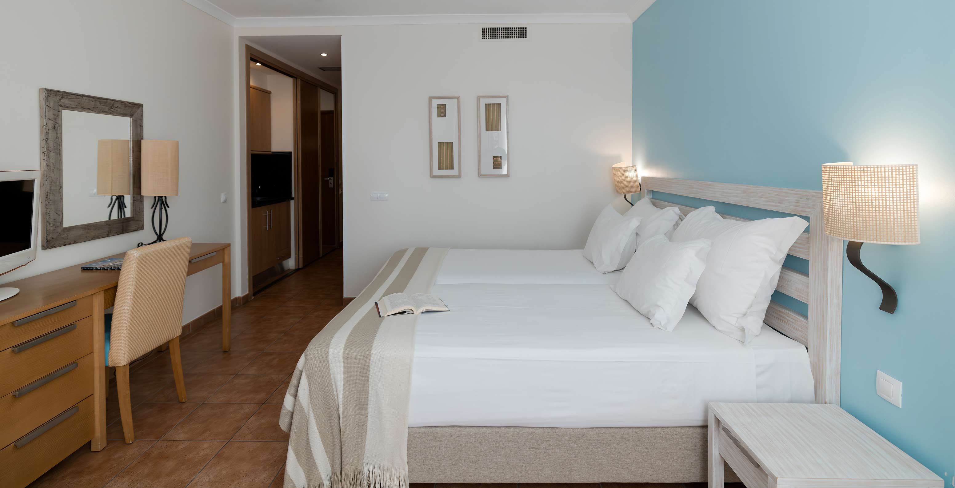 Le Deluxe Vue Mer du Pestana Viking a deux lits, table de chevet et bureau avec chaise