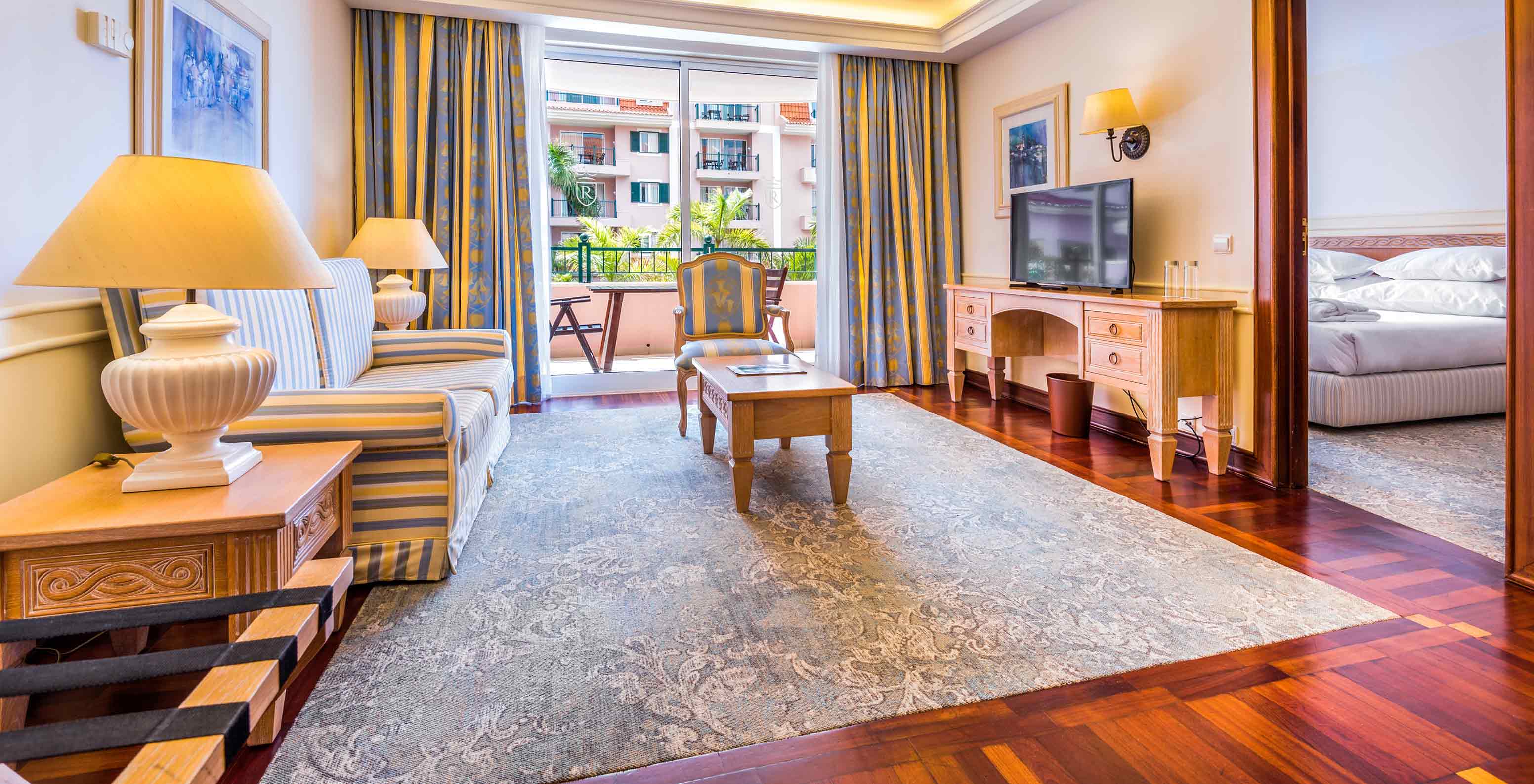 La Suite du Pestana Royal All Inclusive a un salon avec télévision, chaises et un balcon