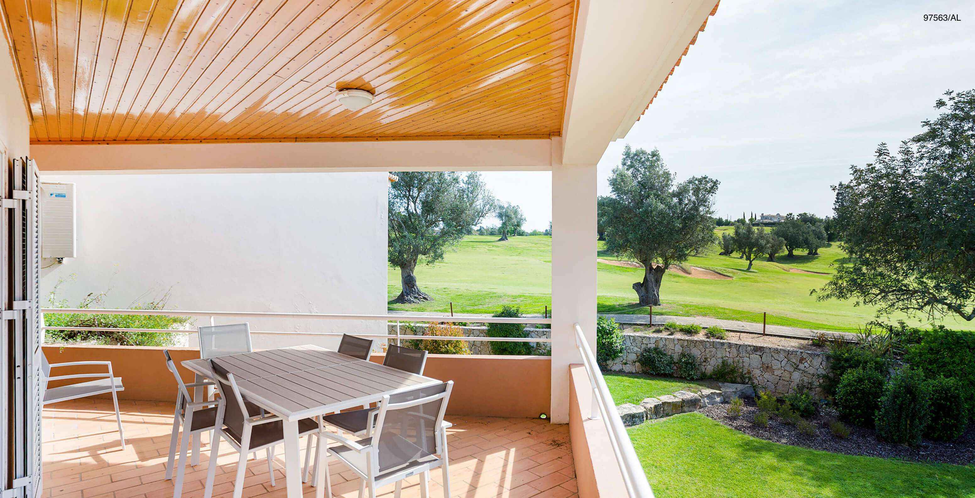 Het appartement Pestana Carvoeiro Golf T3 Superior heeft een balkon met een tafel en stoelen, met uitzicht op de tuin