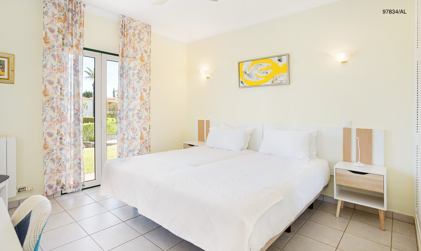 Het appartement Pestana Carvoeiro Golf T2 Superior heeft een slaapkamer met twee eenpersoonsbedden en een nachtkastje