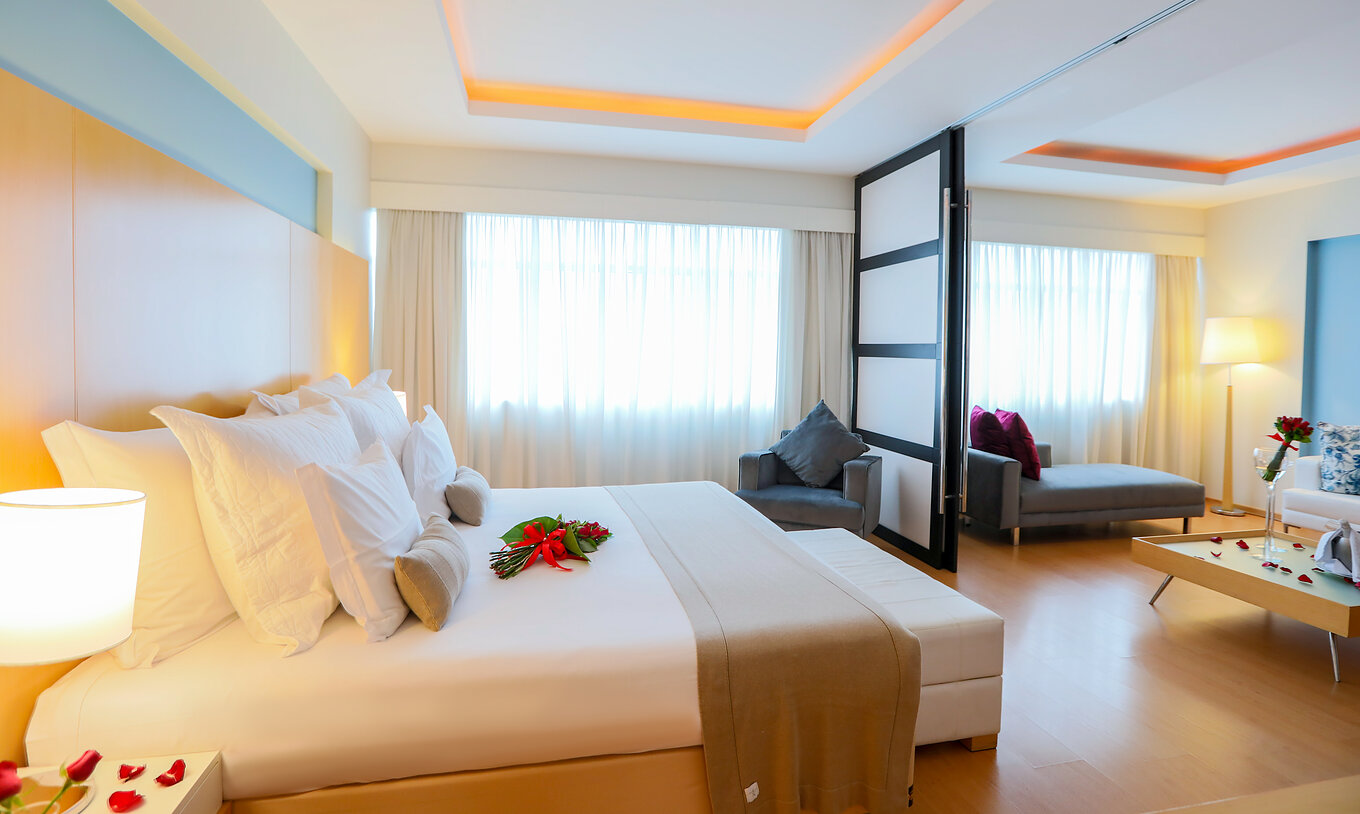 A Suite Master do Pestana Curitiba tem um quarto com cama de casal e uma sala com sofá que pode ser uma cama extra