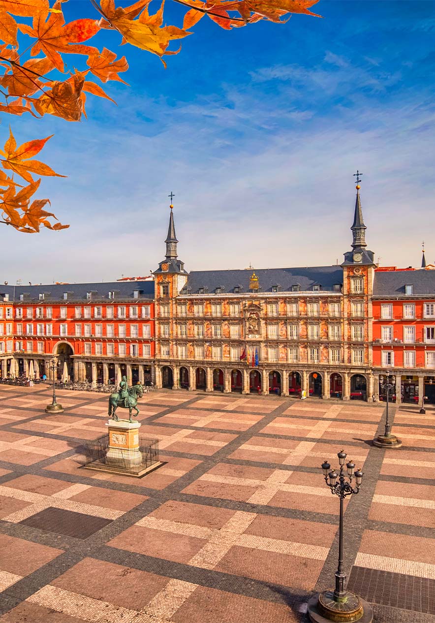 View of Plaza Mayor in Madrid with its historic orange-colored buildings and a large central space