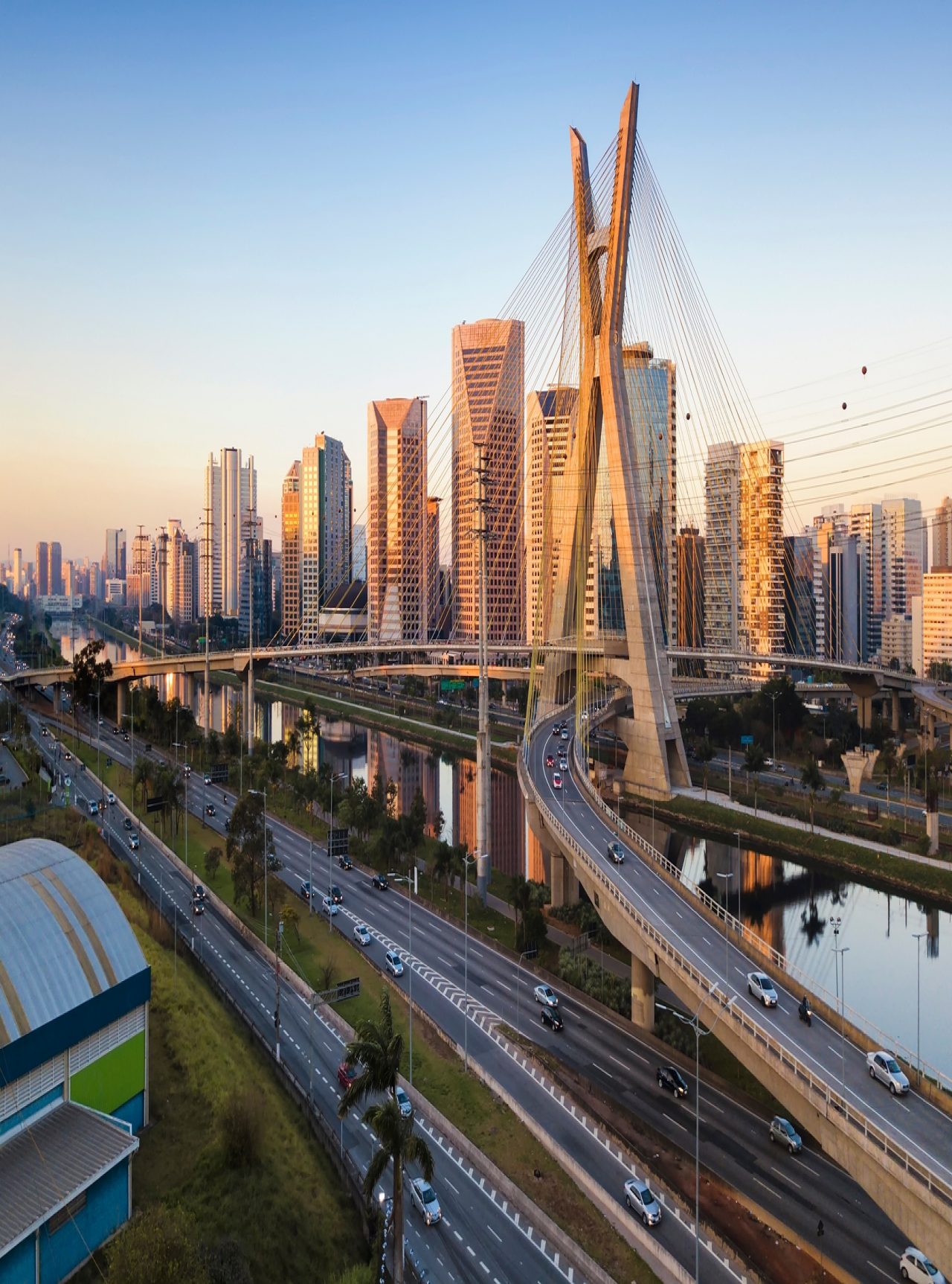 Urban landscape of São Paulo with the Estaiada Bridge crossing the Pinheiros River under a blue sky