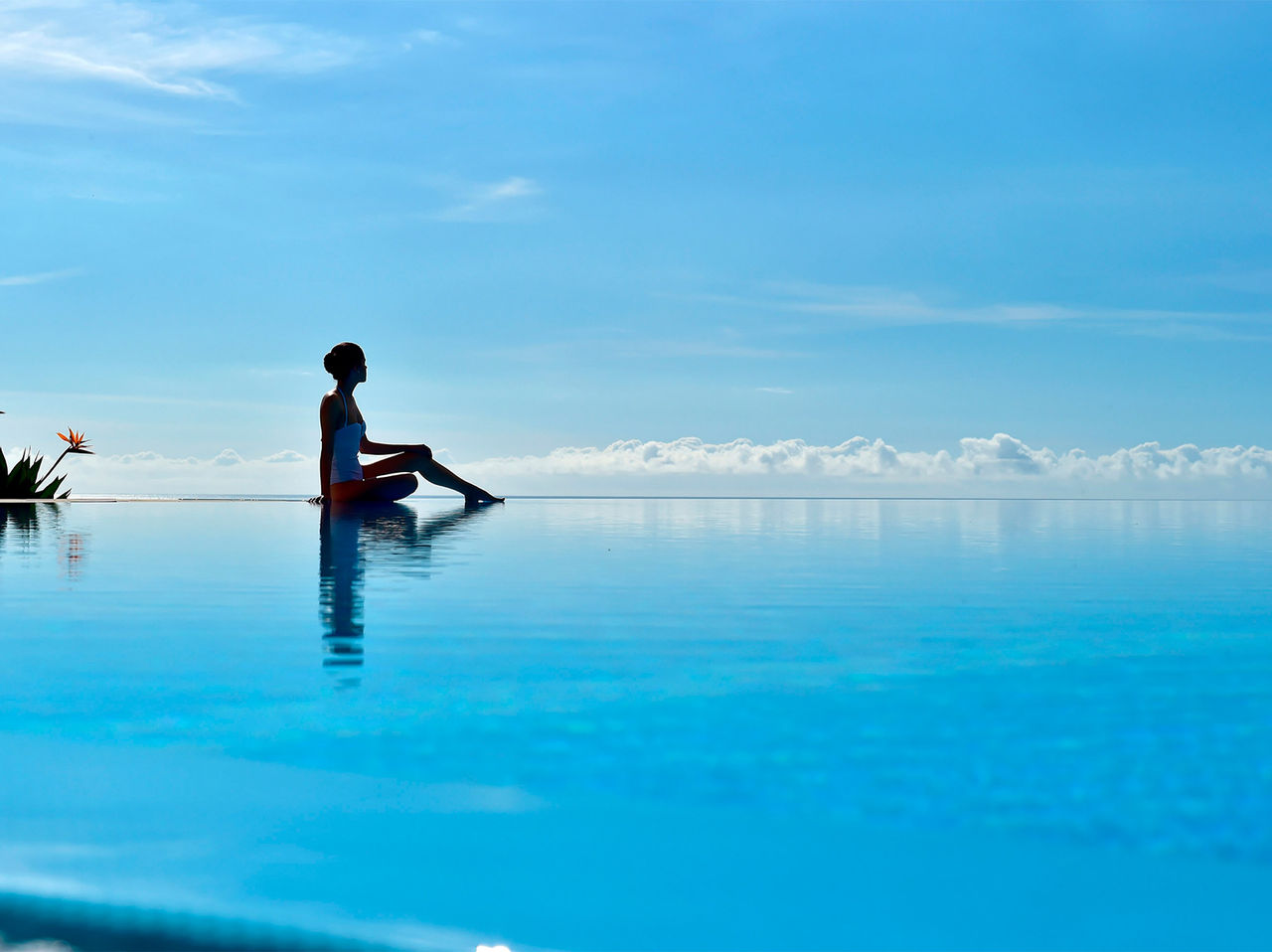 Girl in the infinity pool with a view of the Atlantic Ocean at Pestana Casino Park, a Pestana Hotels & Resorts hotel