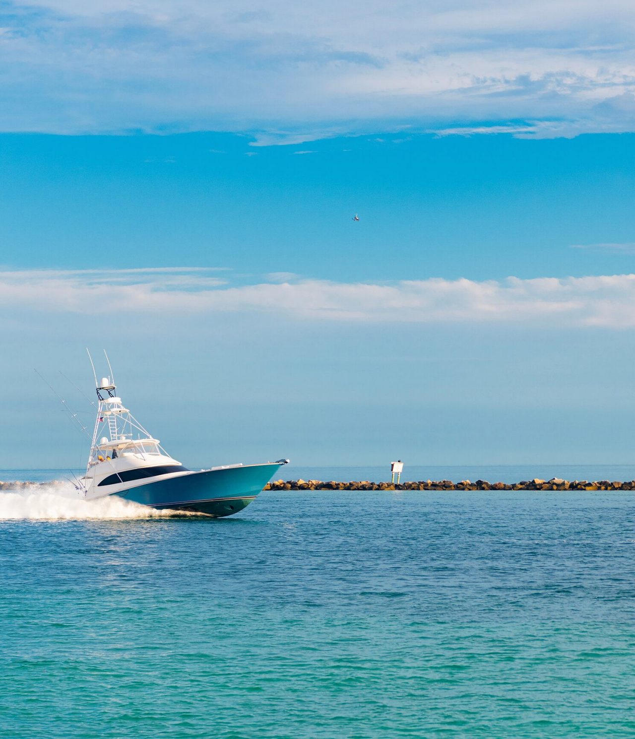 Bateau bleu et blanc entrant dans le ponton de Miami sur une eau bleu cristalline