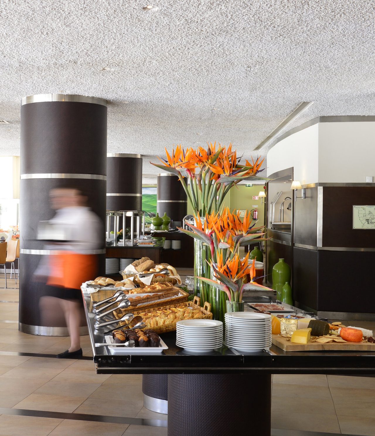 The Green Pines restaurant, at the 5-Star Hotel in Vilamoura, serves a buffet breakfast with several tables for guests