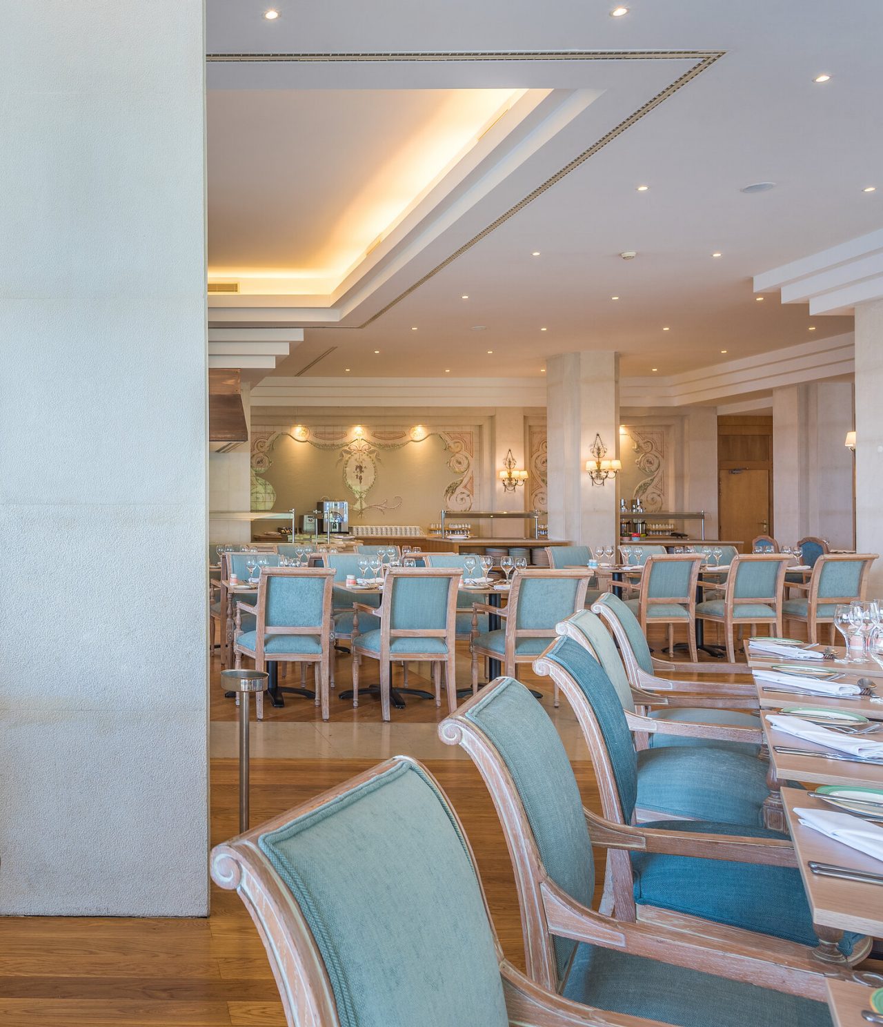 The São Lourenço Garden Terrace restaurant, at the 5-Star Hotel in Funchal, includes a spacious interior with blue chairs