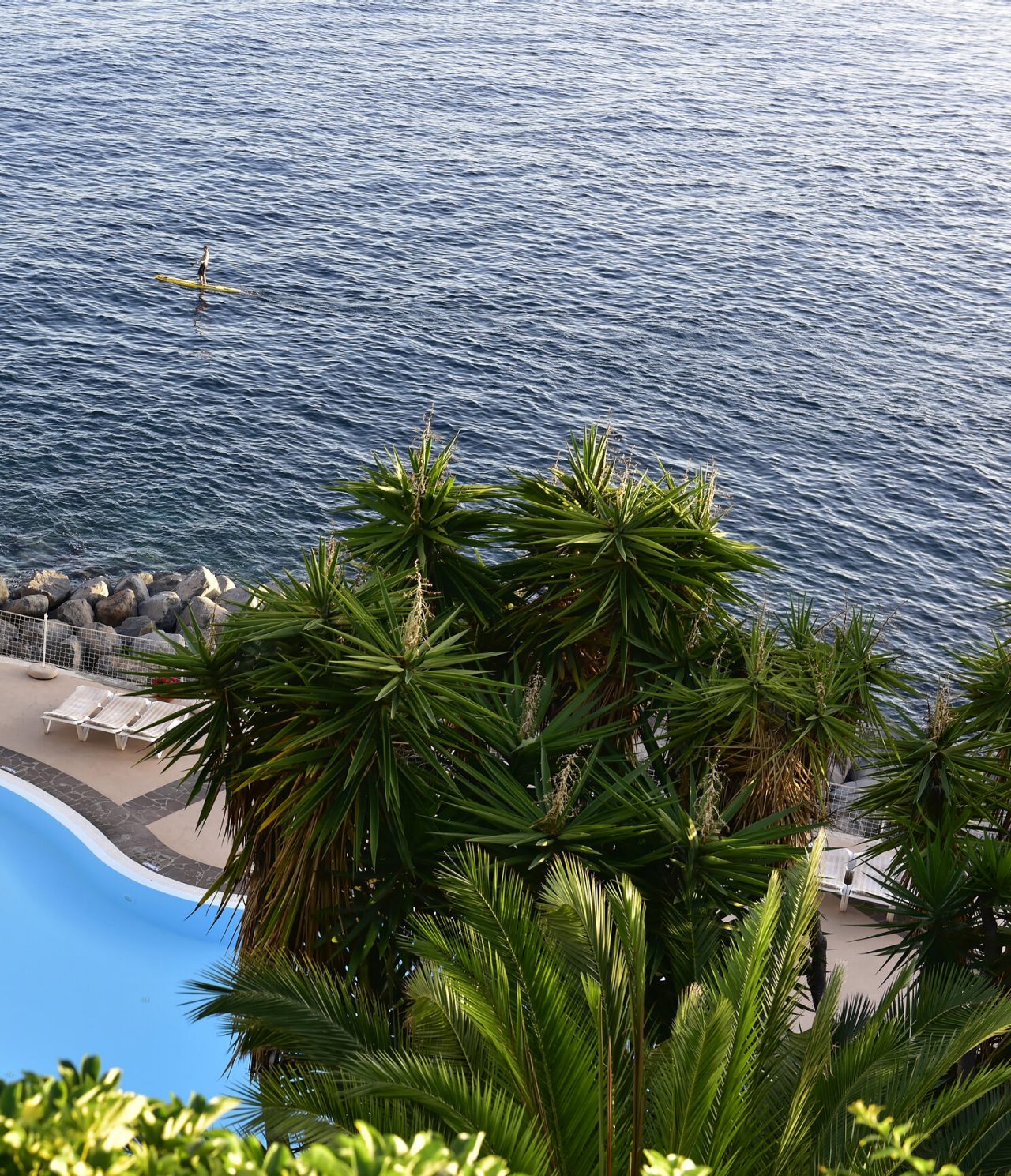 The Pool Bar, at the Hotel with Sea Access in Funchal, has a pool with sea views nearby
